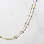 Closeup image of gold beaded chain