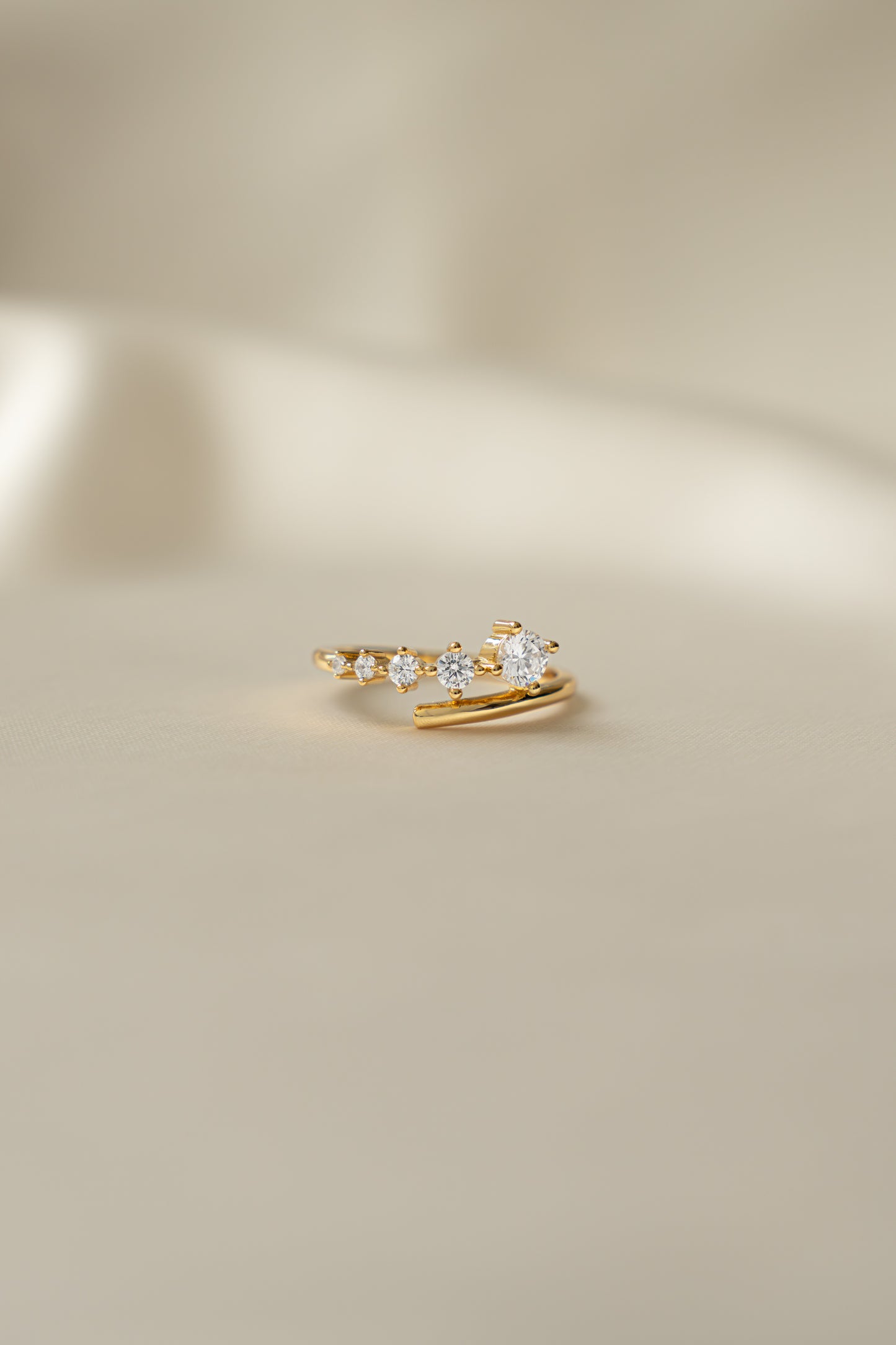 Sami Jewels Dainty Gradient Bypass Ring in 925 Sterling Silver plated in 14k gold on a beige background
