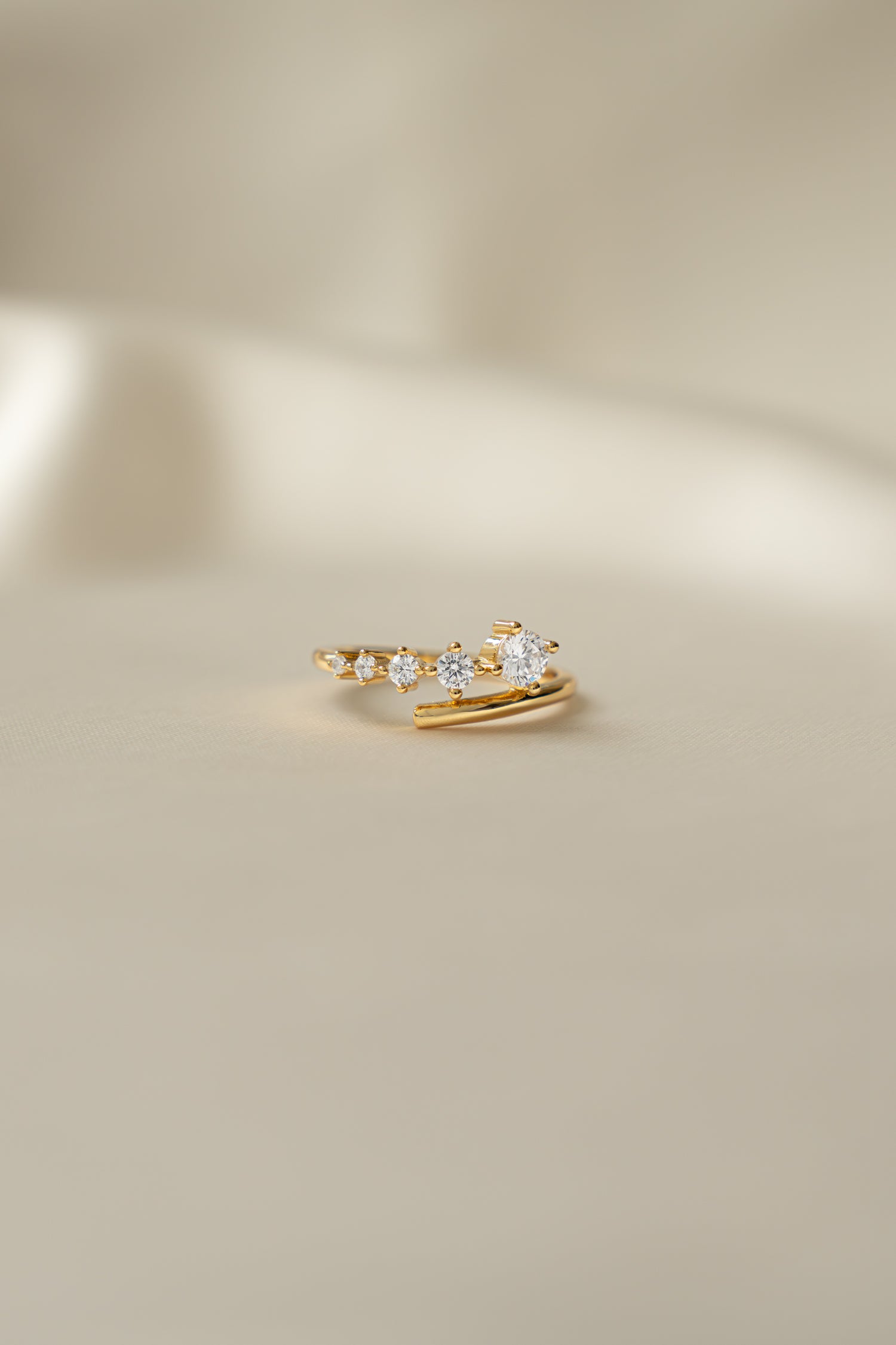 Sami Jewels Dainty Gradient Bypass Ring in 925 Sterling Silver plated in 14k gold on a beige background