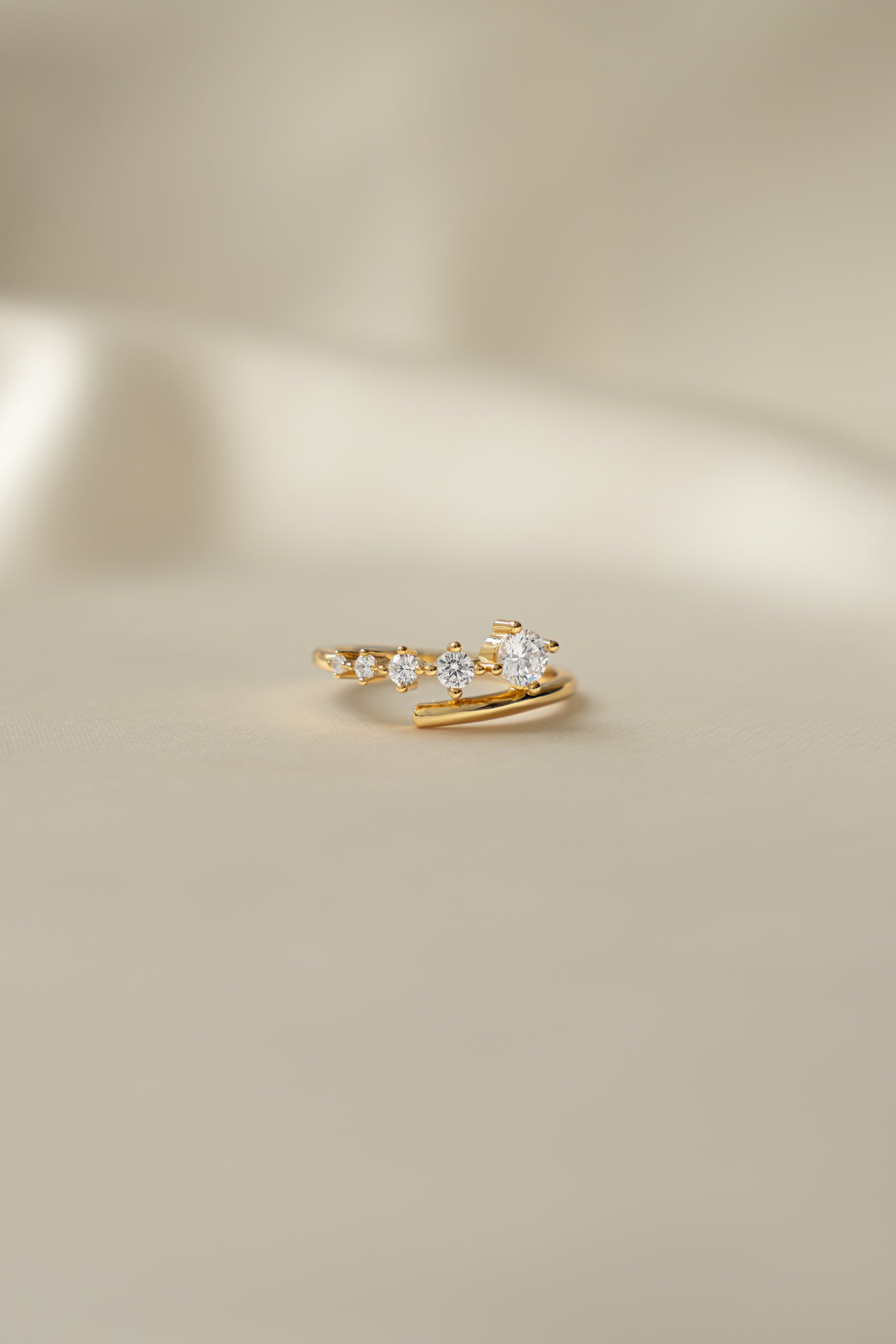 Sami Jewels Dainty Gradient Bypass Ring in 925 Sterling Silver plated in 14k gold on a beige background