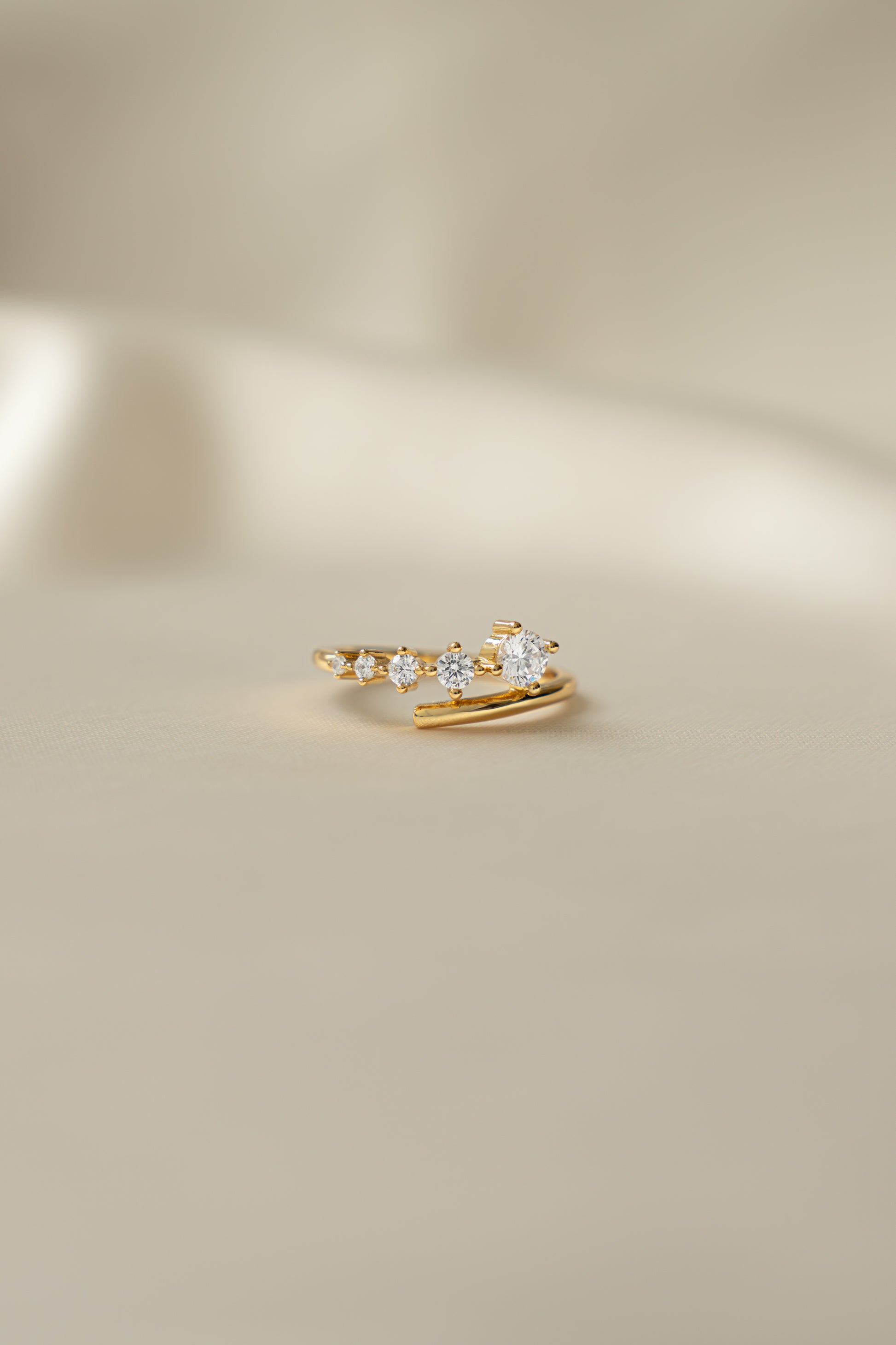 Sami Jewels Dainty Gradient Bypass Ring in 925 Sterling Silver plated in 14k gold on a beige background