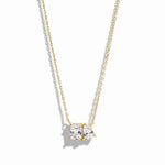 closeup image of gold necklace with pear and emerald cut stone