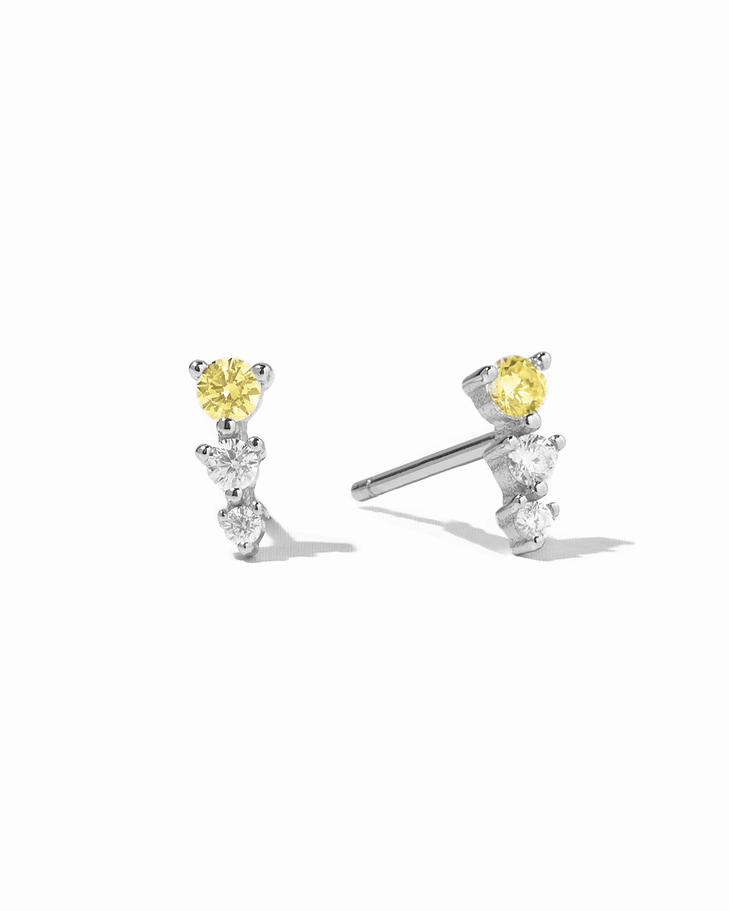 Sterling silver stud earrings with yellow and diamond stones.