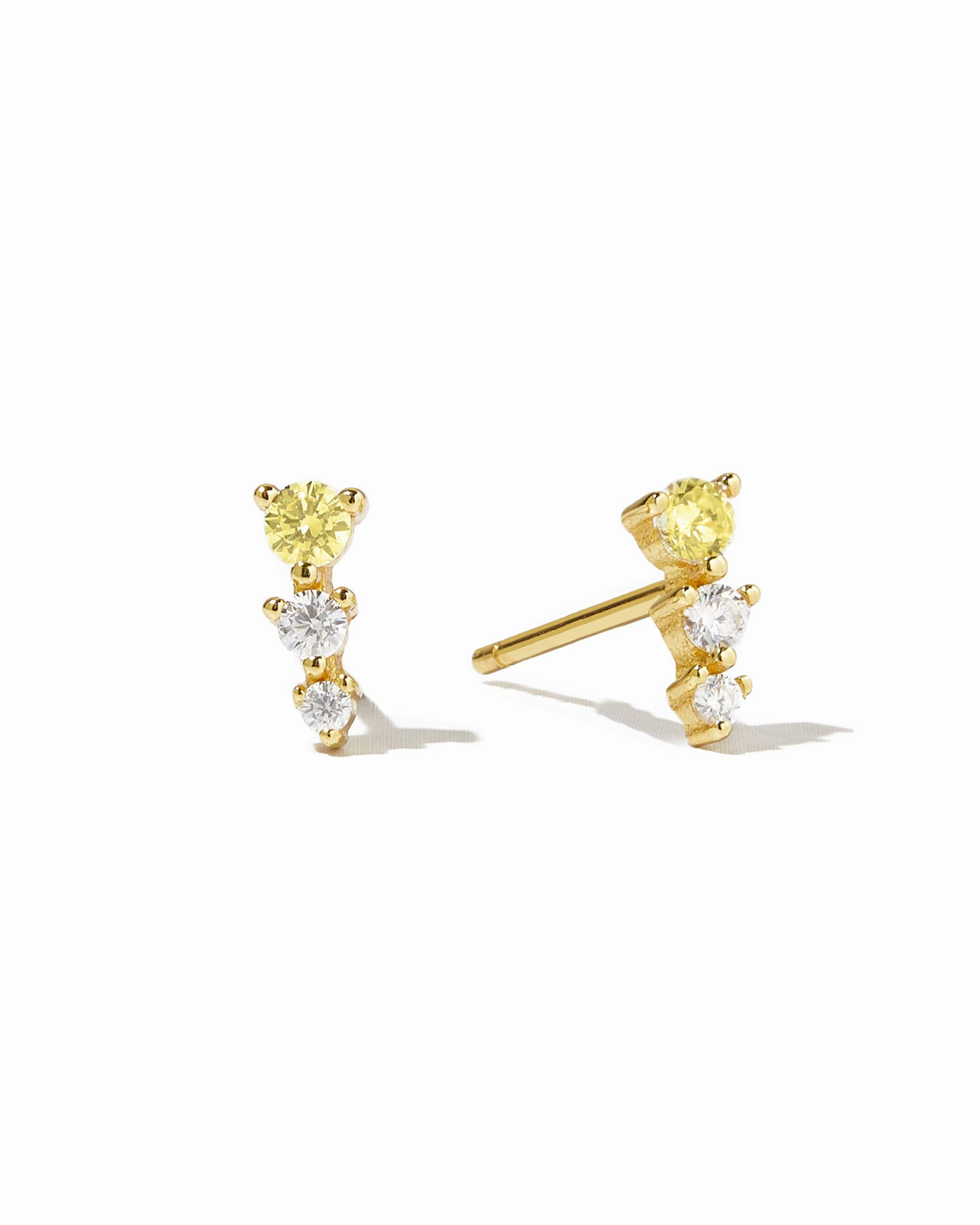 Gold earl climber stud earrings with yellow and diamond stones.