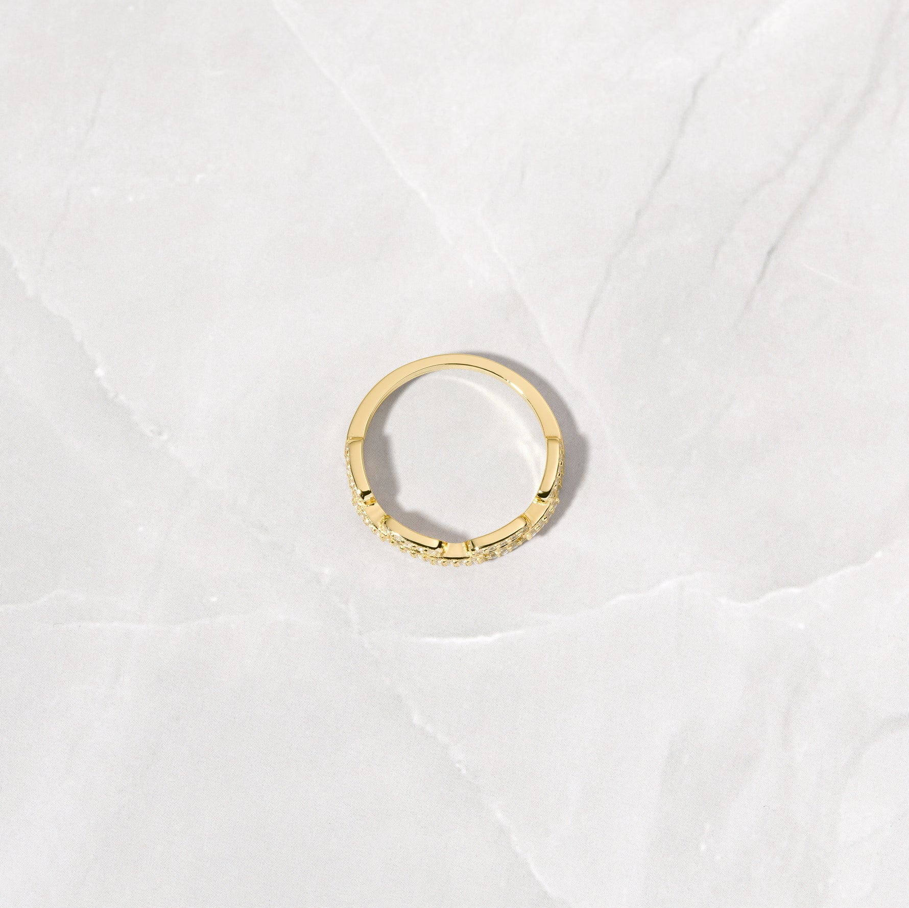 Bird's eye view of gold pave chain link ring. 