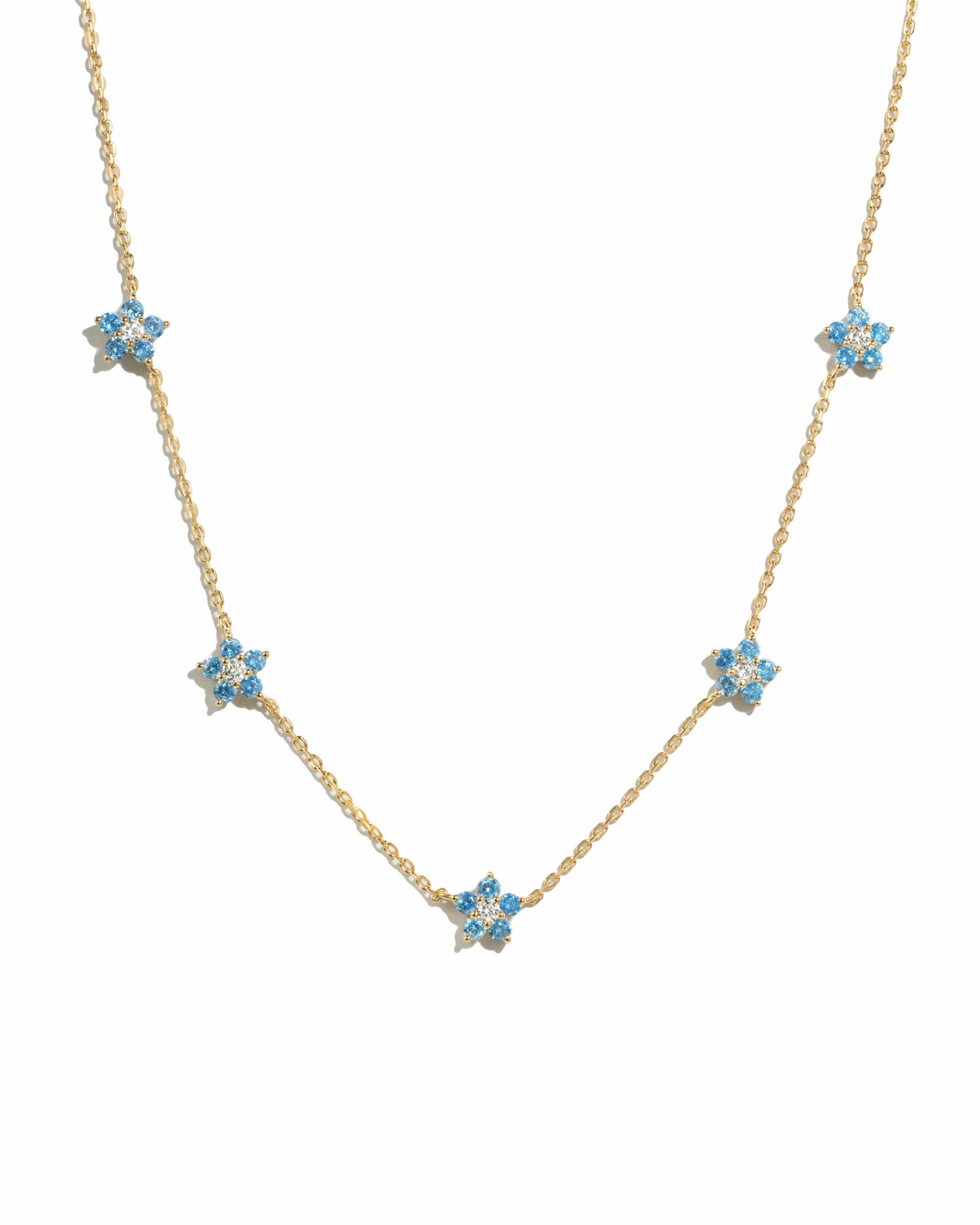 Gold Aqua Flower Necklace by Sami Jewels featuring a delicate aqua-colored flower pendant on a fine chain.