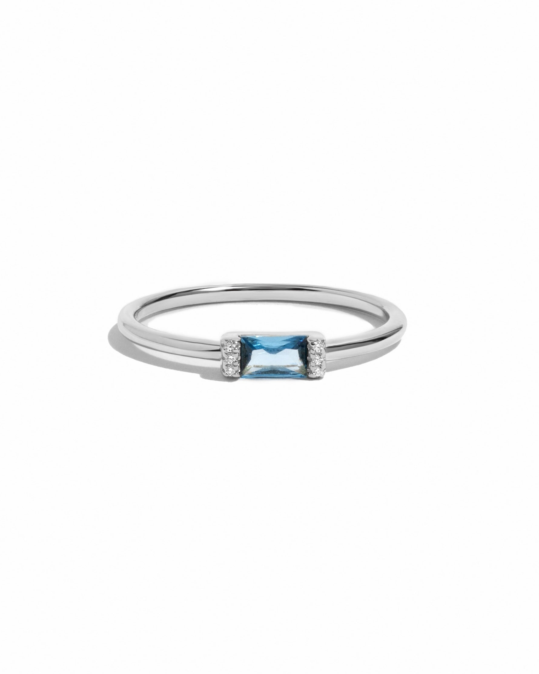 Sterling silver aquamarine baguette ring with a simple design, featuring a rectangular aquamarine gemstone on a white background.