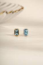 Sami Jewels aquamarine baguette stud earrings in gold and sterling silver with rectangular gemstone design.