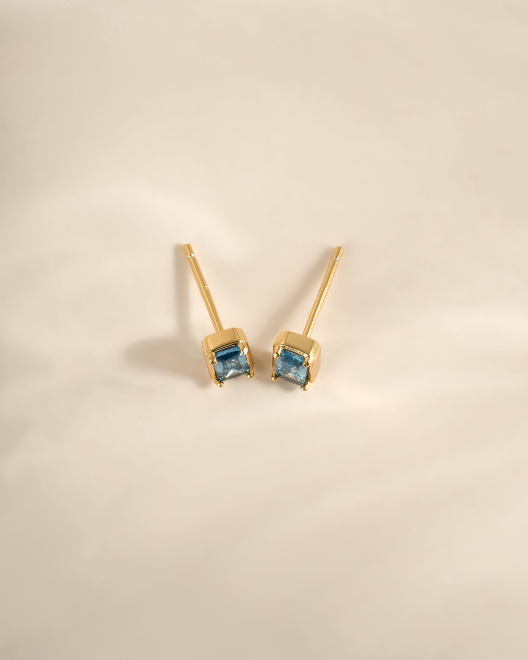 Gold aquamarine baguette stud earrings by Sami Jewels, top view showcasing elegant gemstone cuts and sleek design