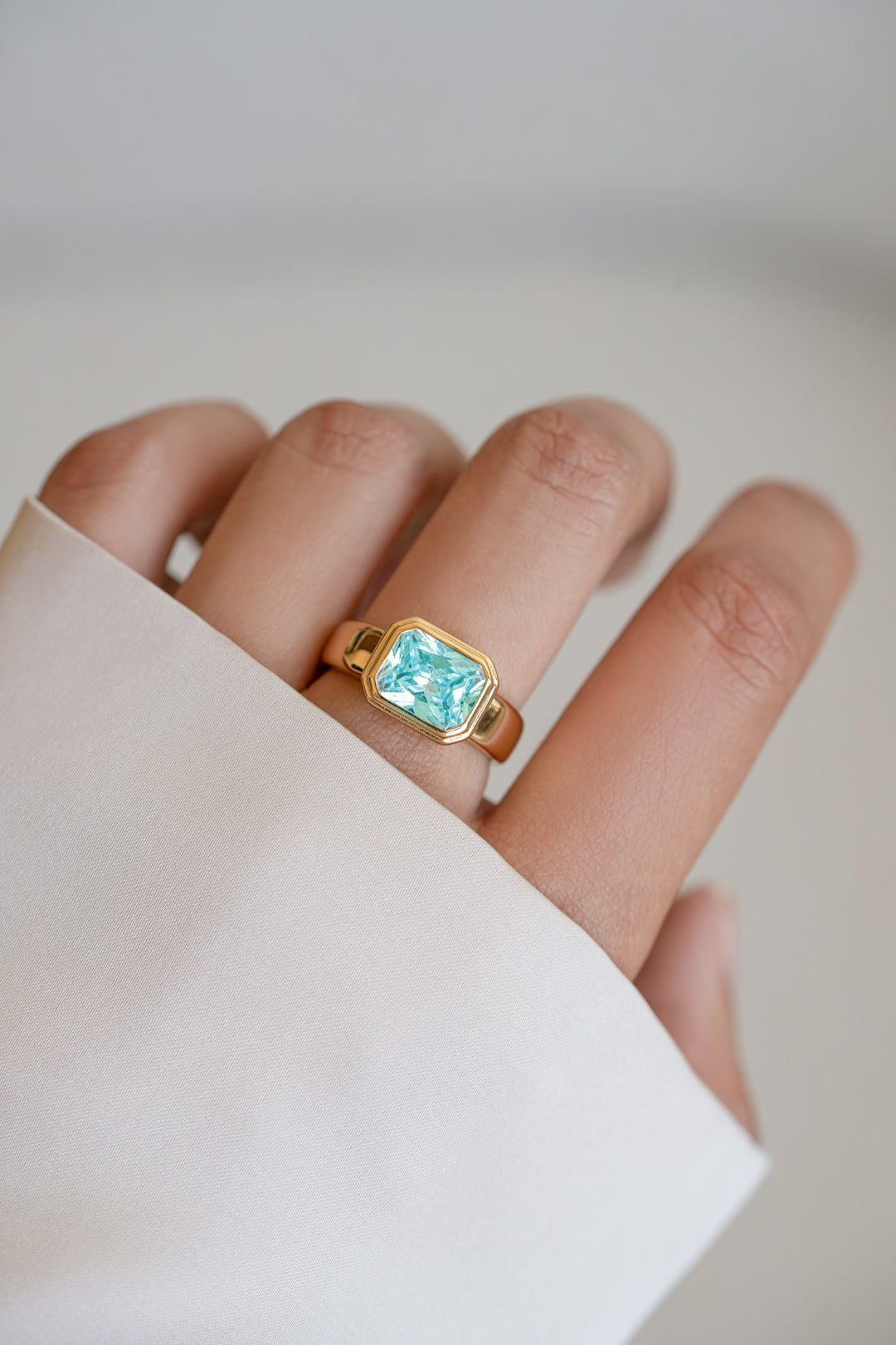 Rectangular aquamarine ring with gold bezel setting, showcasing a stylish jewelry piece from Sami Jewels.