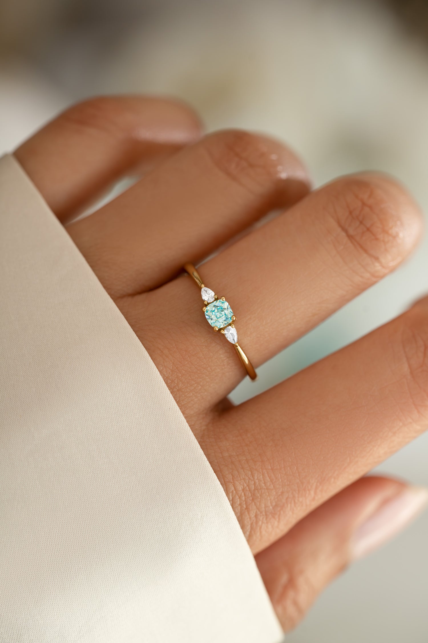 aquamarine cushion ring in gold on model