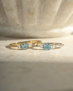 aquamarine cushion ring in gold and sterling silver on a neutral background