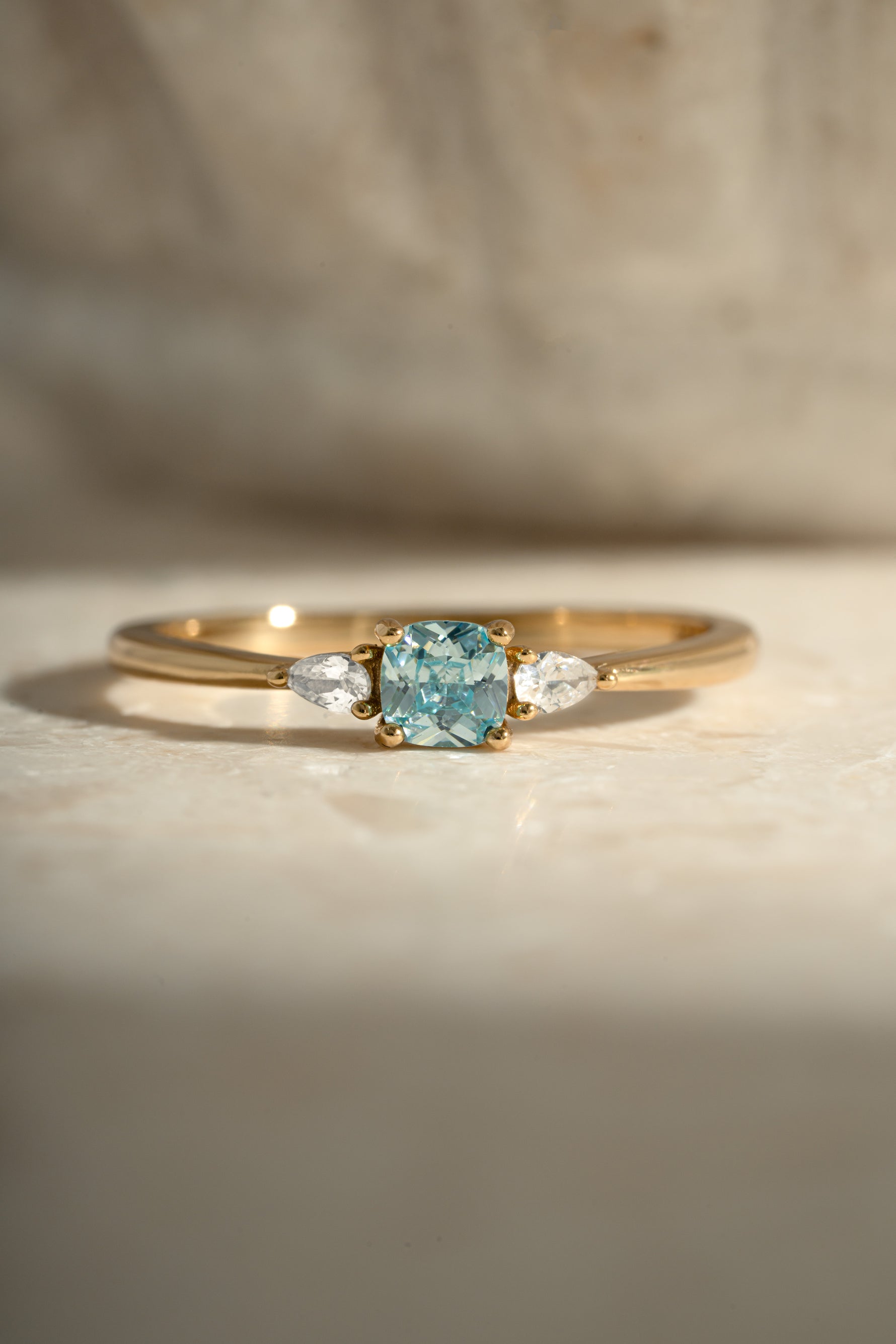 aquamarine cushion ring in gold closeup view