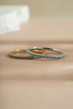 gold  and sterling silver aquamarine birthstone eternity ring neutral background