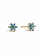 Gold aquamarine flower stud earrings by Sami Jewels displayed on a white background.
