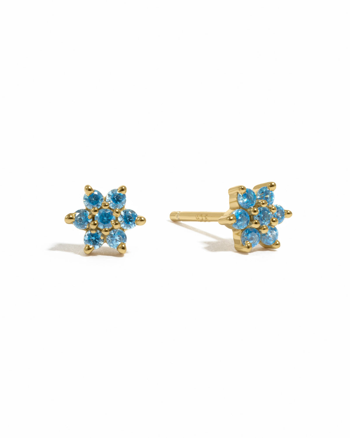 Gold aquamarine flower stud earrings by Sami Jewels displayed on a white background.