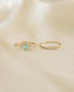 Gold aquamarine ring set by Sami Jewels featuring multiple elegant rings with aquamarine gemstones, front view display.