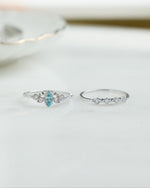 Sterling silver aquamarine ring set by Sami Jewels featuring three elegant gemstone rings with intricate design details.