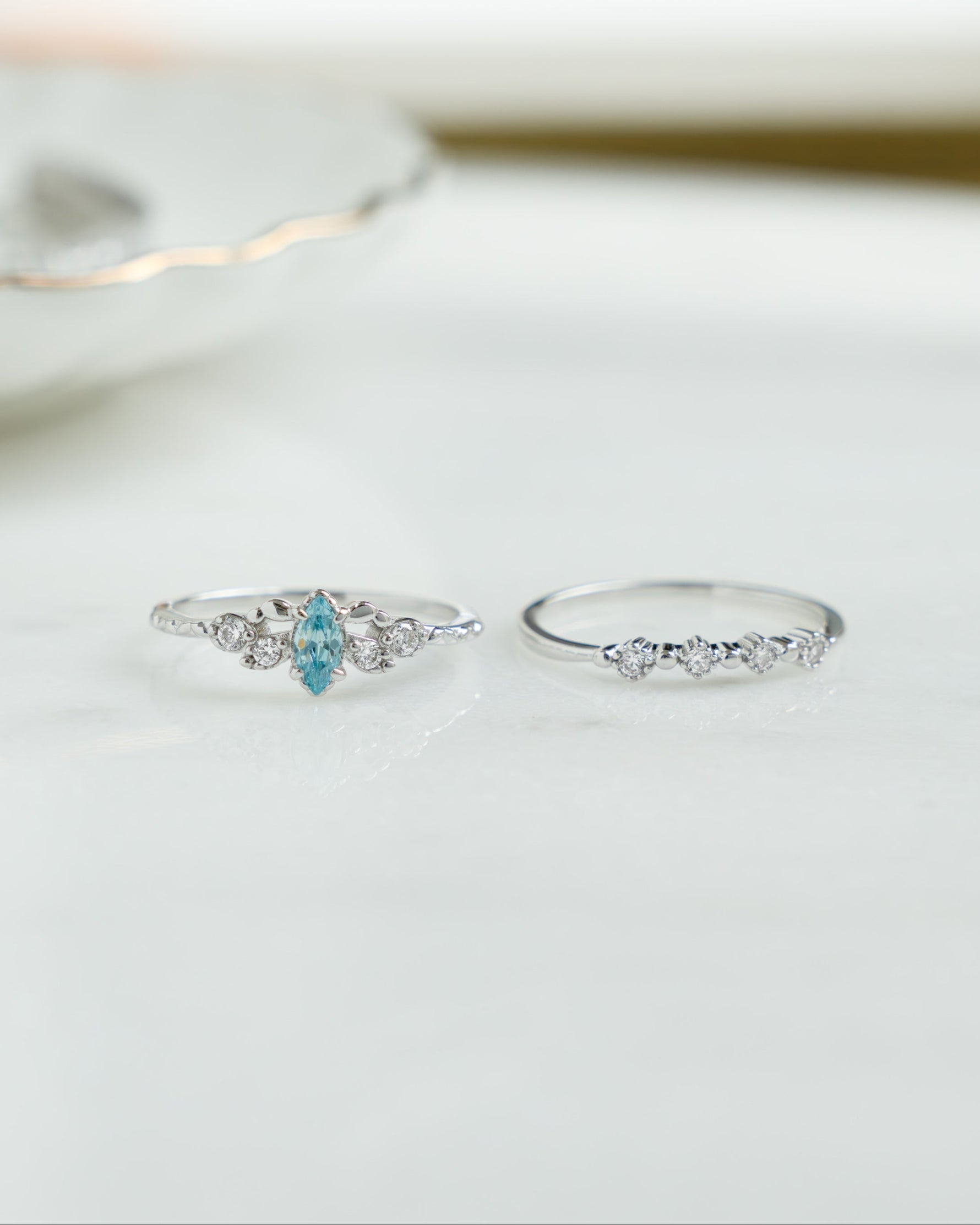 Sterling silver aquamarine ring set by Sami Jewels featuring three elegant gemstone rings with intricate design details.