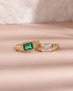 sterling silver  and gold emerald and diamond baguette cut statement rings light pink background 