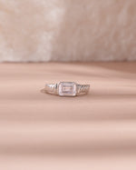 sterling silver diamond baguette cut statement ring light pink background 