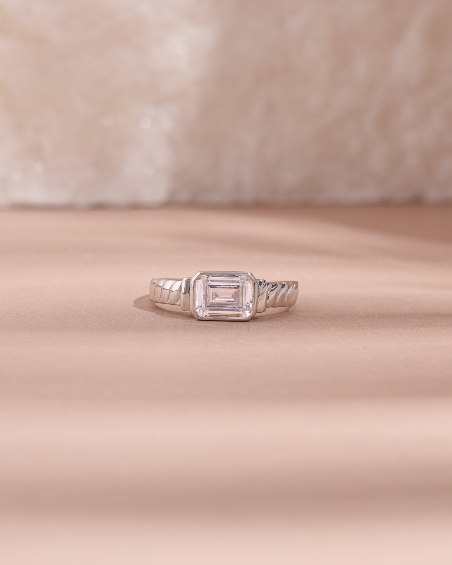 sterling silver diamond baguette cut statement ring light pink background 