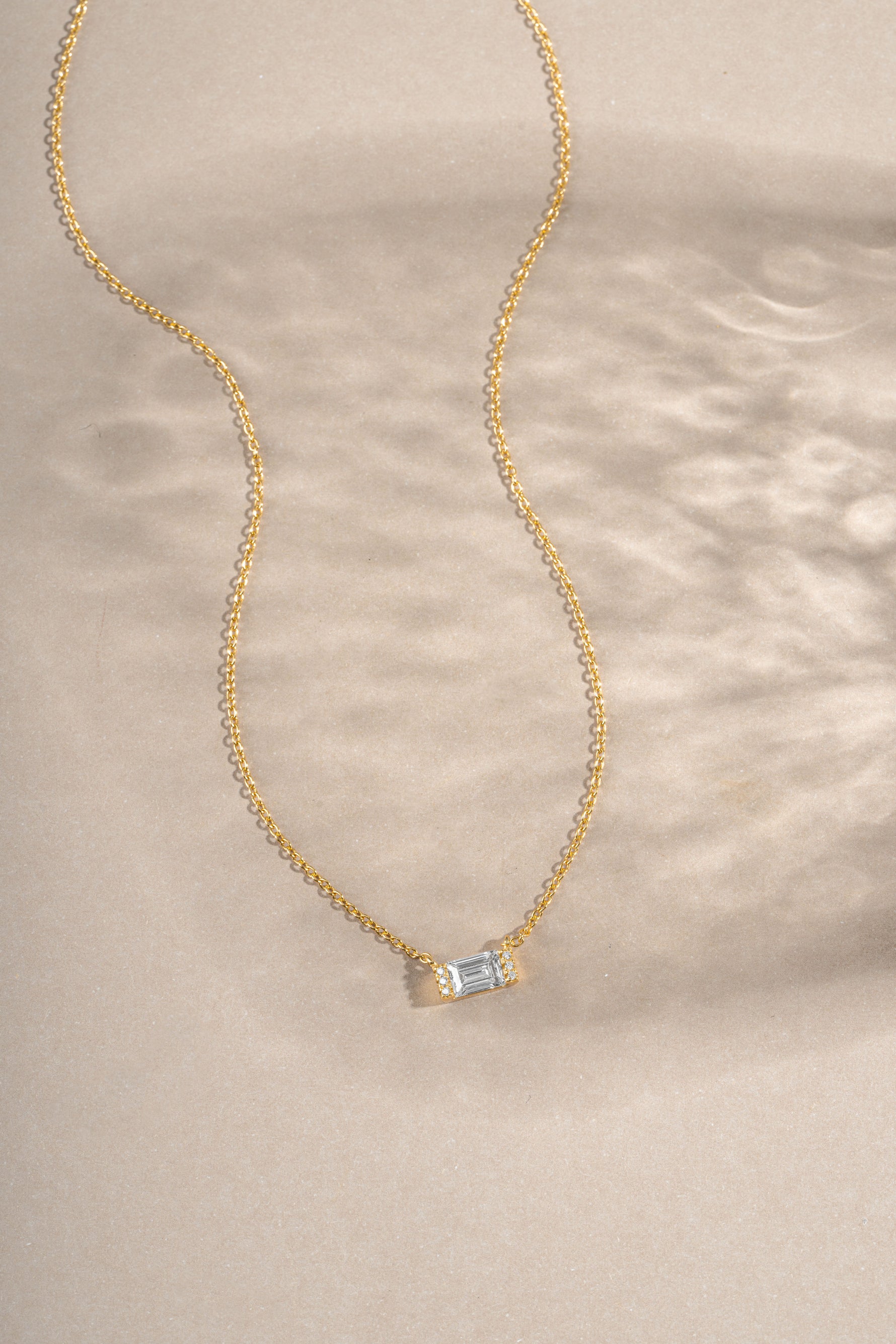 Gold Baguette Necklace by Sami Jewels featuring a sparkling diamond baguette pendant on a delicate chain.