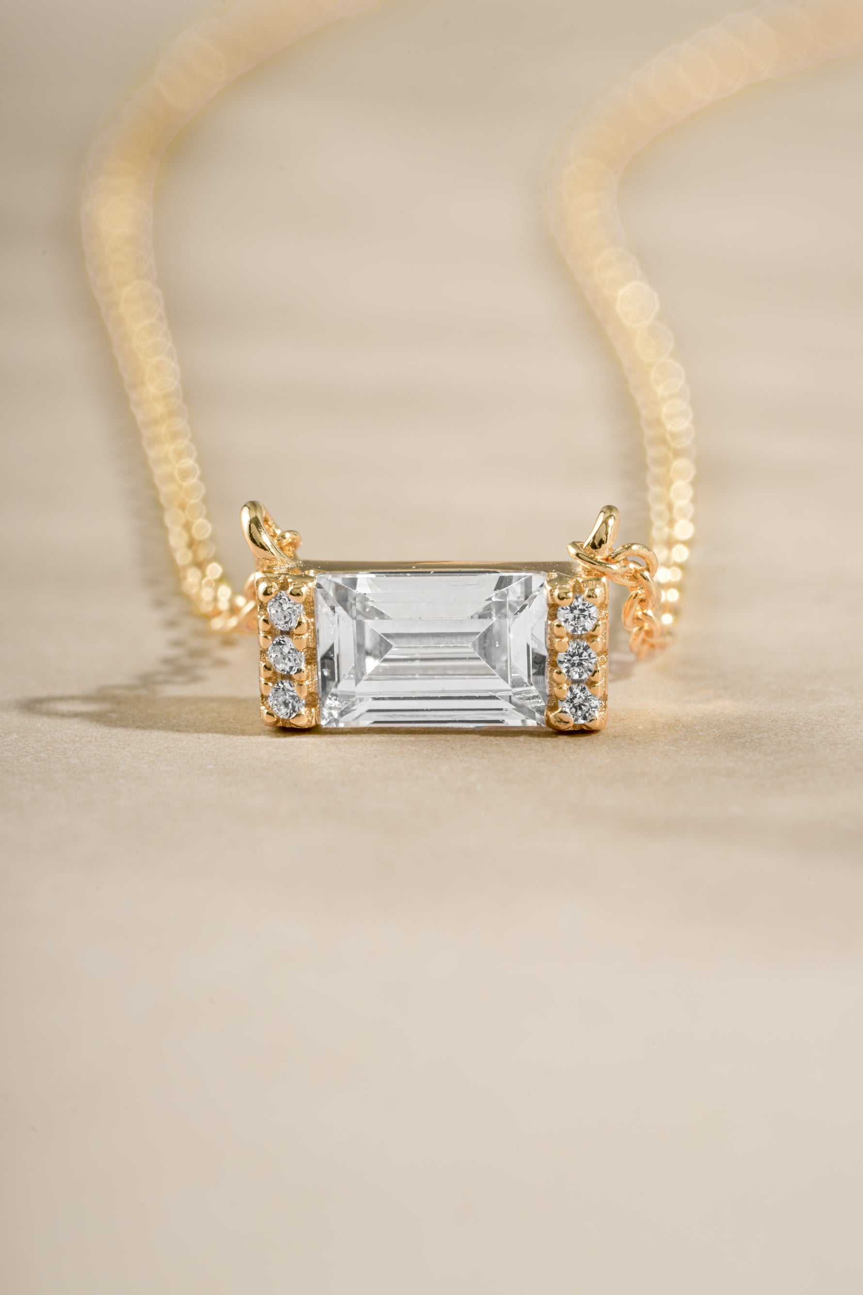 Gold Baguette Diamond Necklace by Sami Jewels featuring a sleek baguette-cut diamond and elegant stone details.