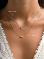 Sterling silver baguette diamond necklace with small and medium stones from Sami Jewels, displayed on a model.