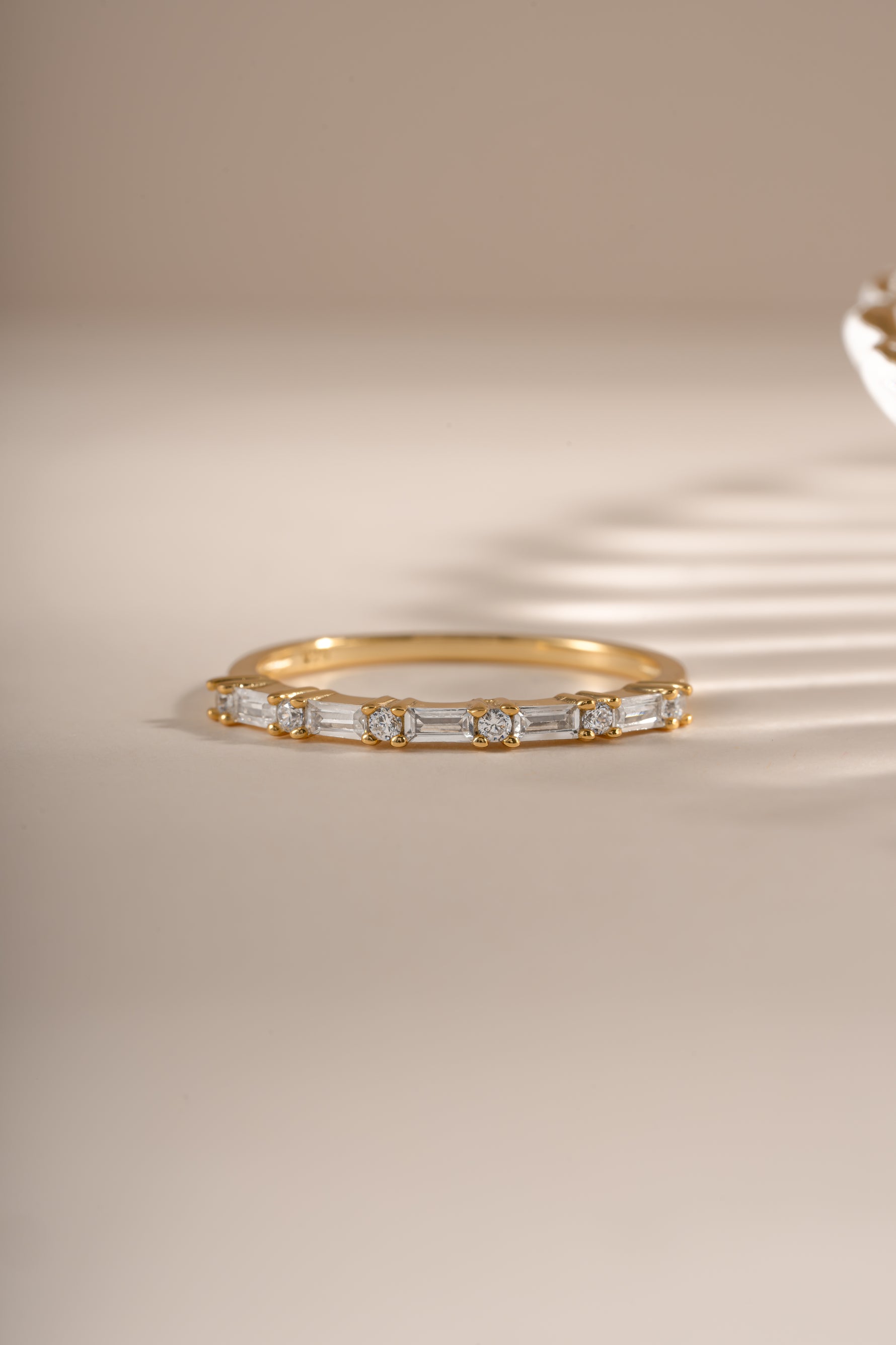 Gold baguette diamond stacking ring by Sami Jewels, front view showcasing sleek design and sparkling gemstones.