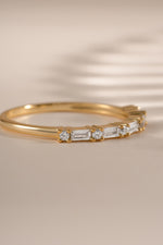 Gold baguette diamond stacking ring by Sami Jewels, side view showcasing elegant design and sparkling gemstones.