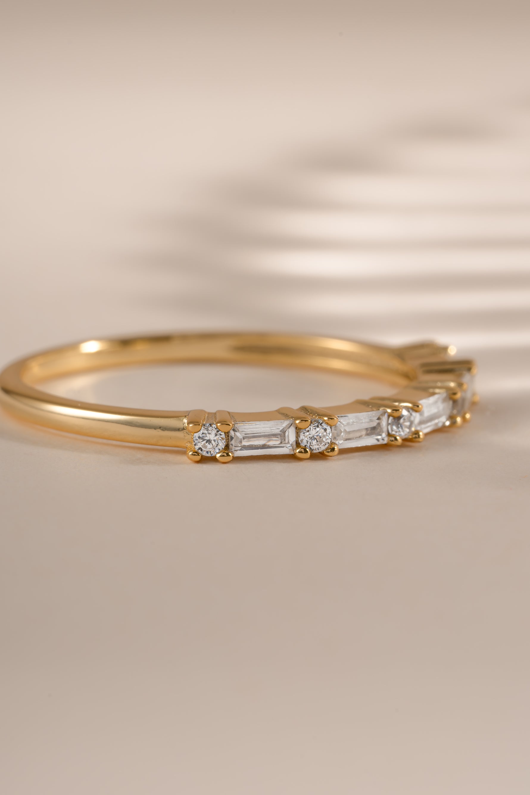 Gold baguette diamond stacking ring by Sami Jewels, side view showcasing elegant design and sparkling gemstones.