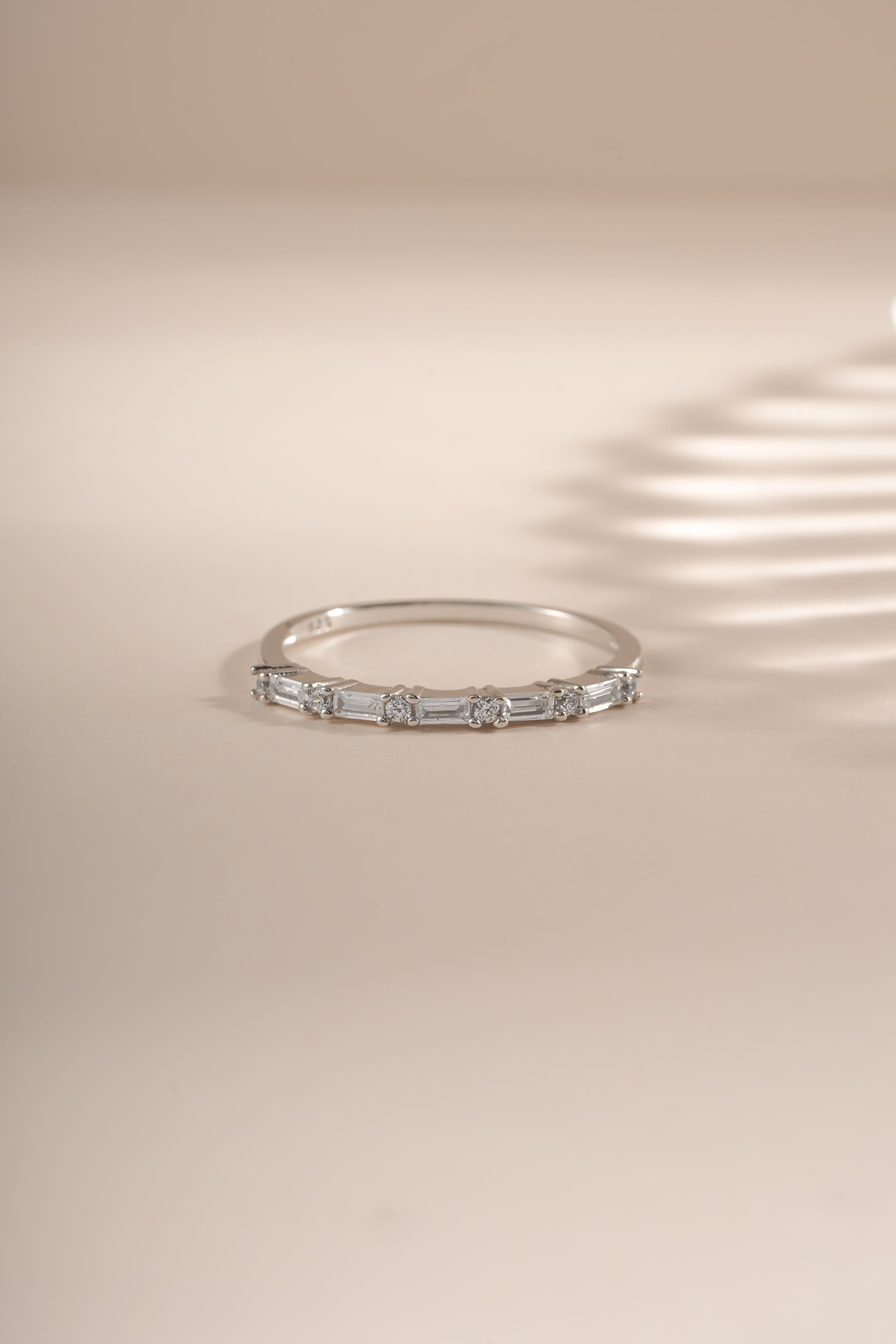 Sami Jewels Baguette Diamond Stacking Ring in sterling silver, featuring a row of baguette-cut diamonds on the front view.