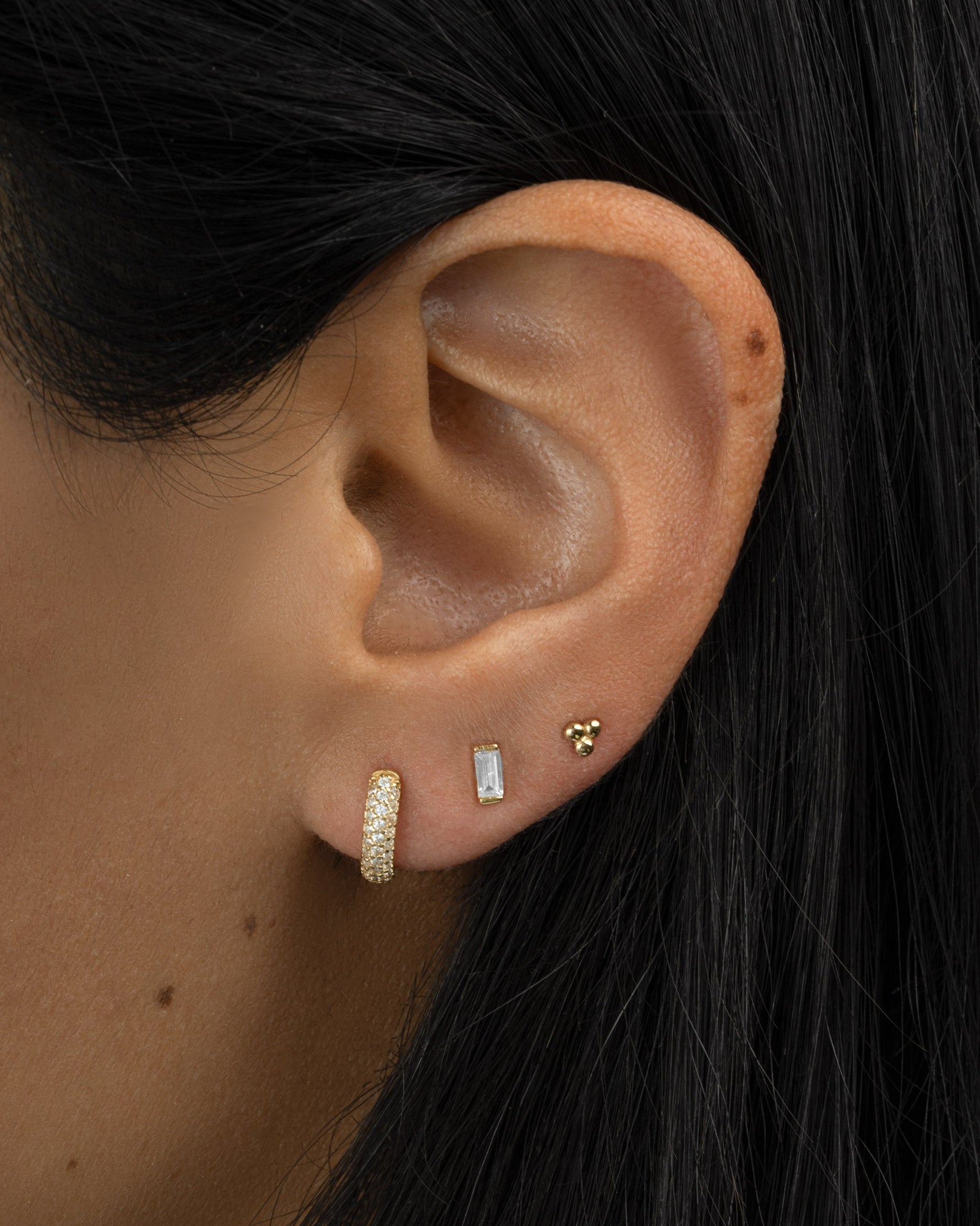 baguette cut diamond stud earrings in gold on model
