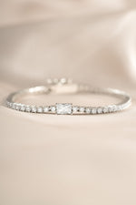 Silver tennis bracelet by Sami Jewels featuring a baguette diamond charm and elegant design.