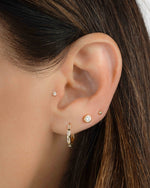 Gold baguette hoop earrings from Sami Jewels, featuring sleek, modern jewelry design worn by a model.