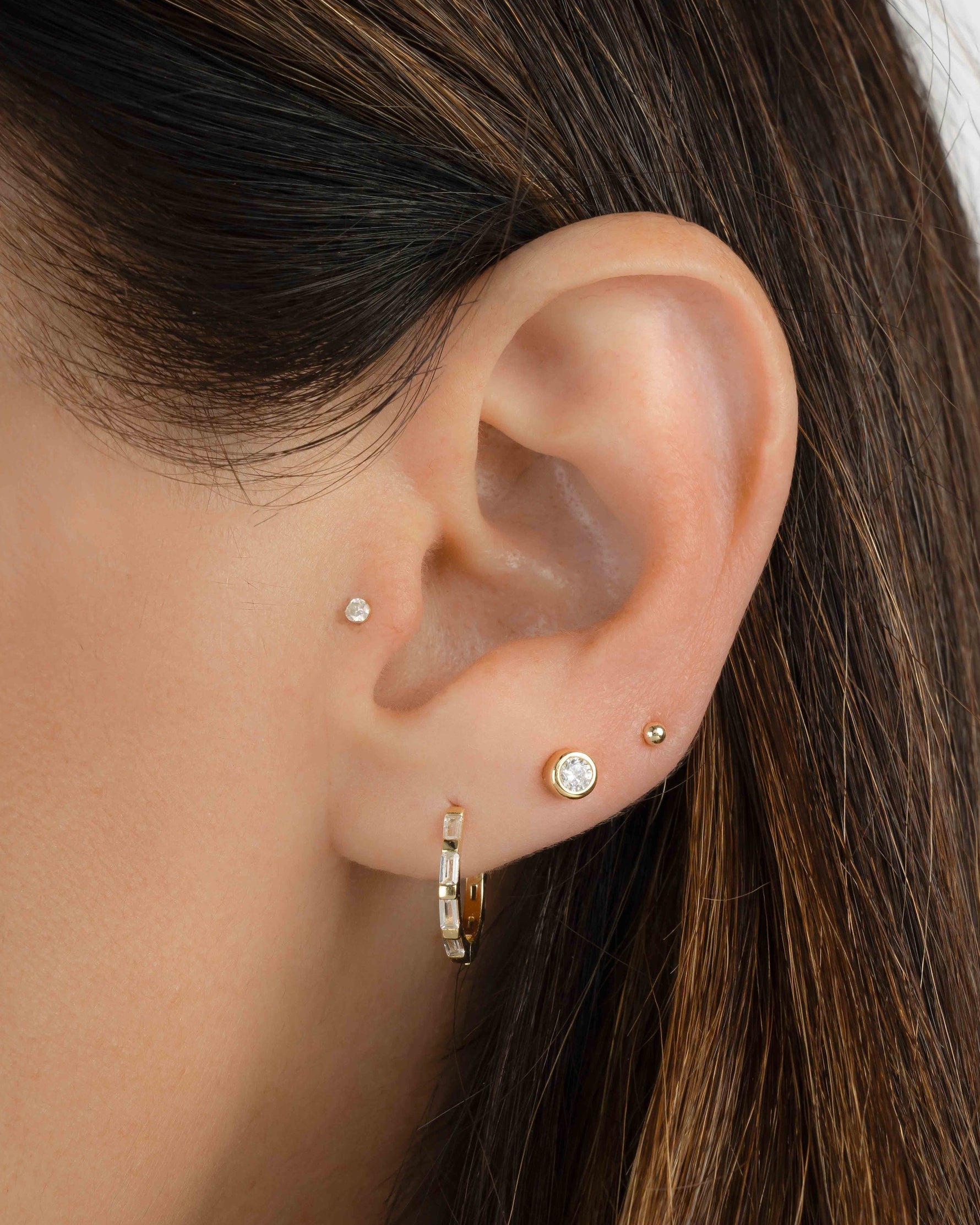 Gold baguette hoop earrings from Sami Jewels, featuring sleek, modern jewelry design worn by a model.