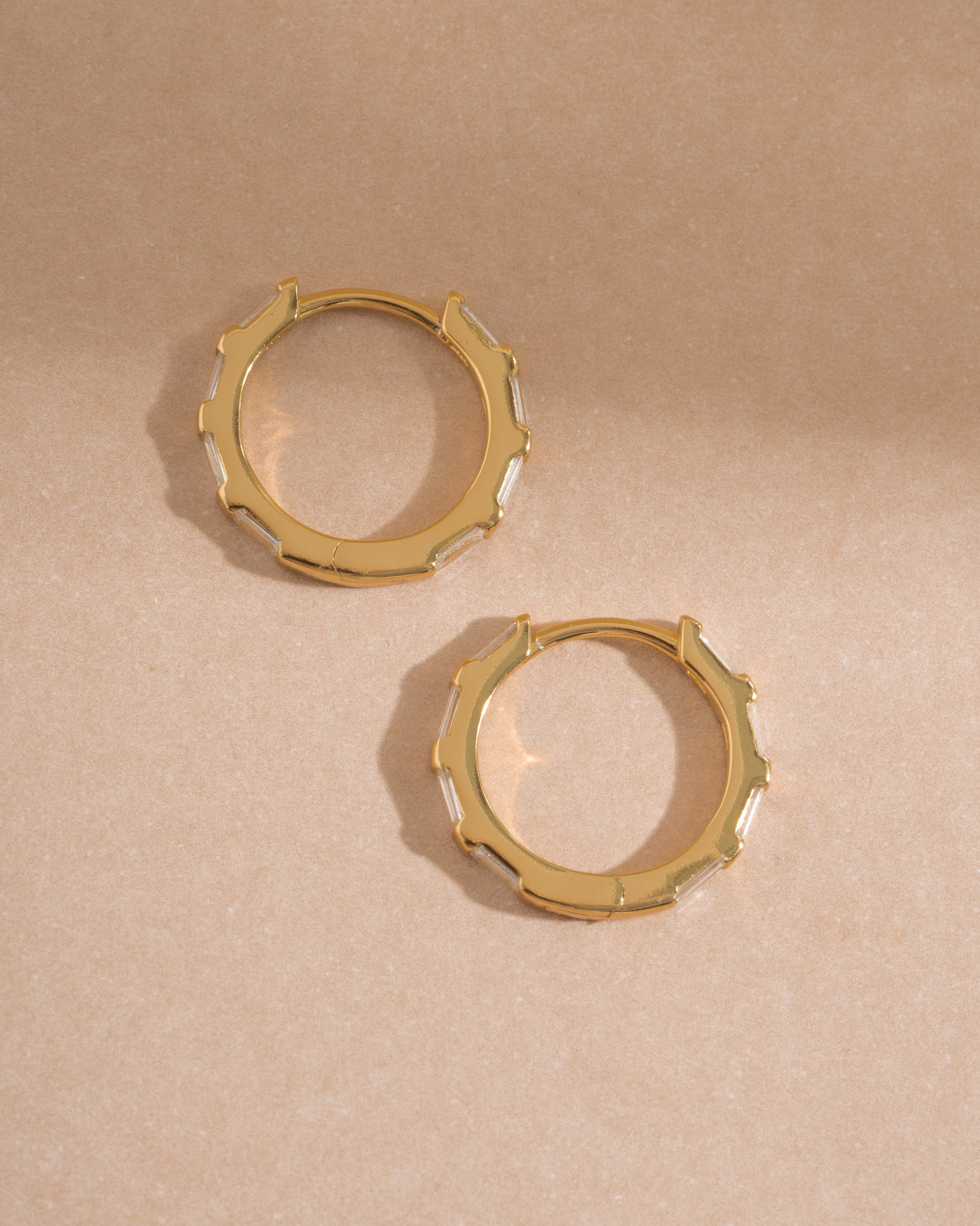 Sami Jewels Baguette Hoop Earrings shown in profile with sleek, rectangular baguette design in gold-tone metal.