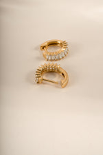 Close-up of gold Daryl-Ann's Baguette Hoops earrings by Sami Jewels, showcasing the baguette-cut design and huggie style.