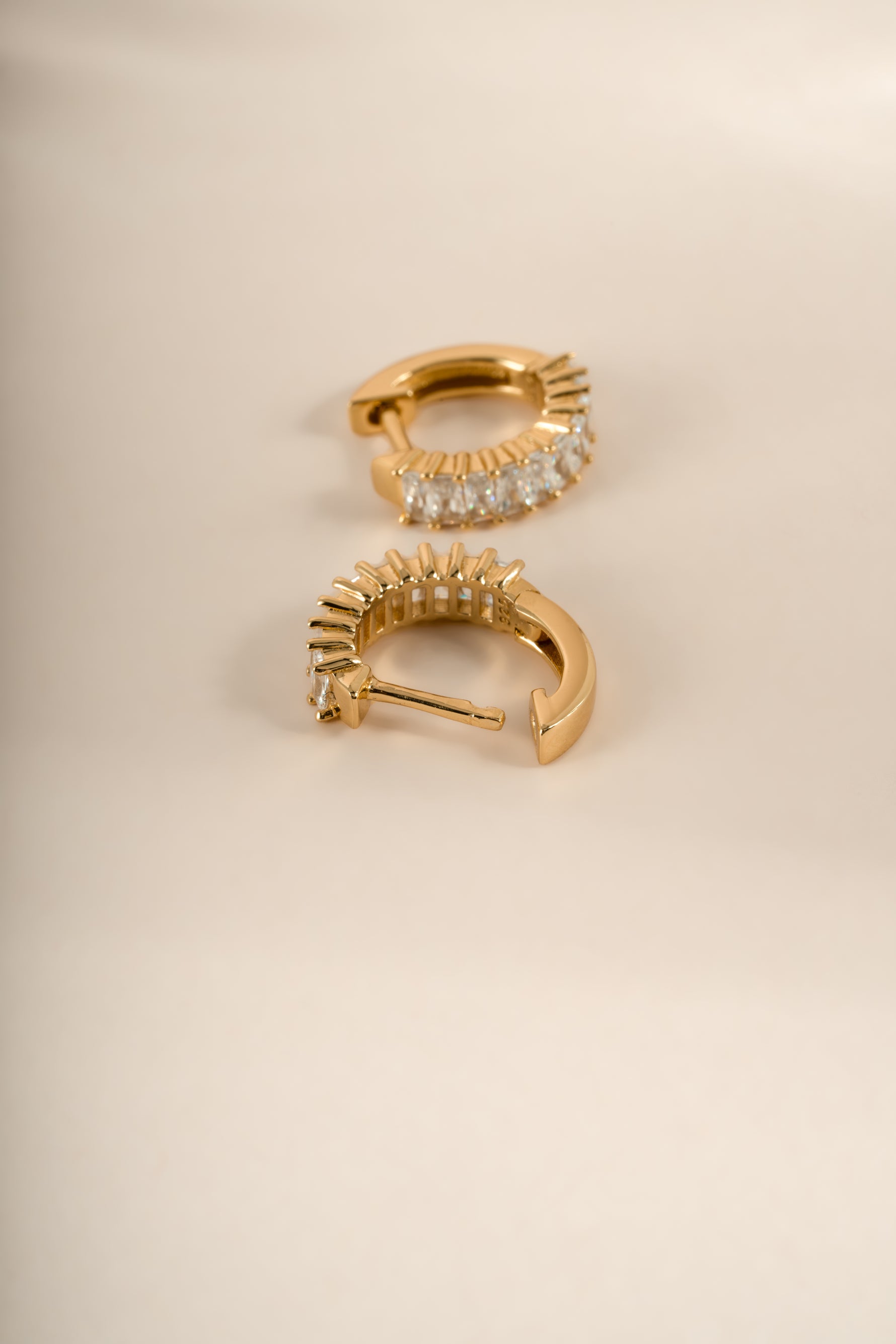 Close-up of gold Daryl-Ann's Baguette Hoops earrings by Sami Jewels, showcasing the baguette-cut design and huggie style.