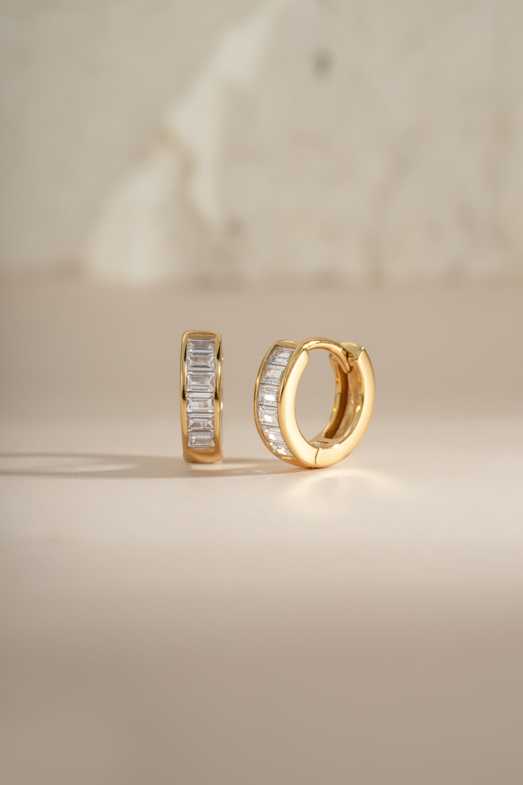 Gold Small Baguette Huggies earrings by Sami Jewels, featuring sleek baguette-cut design in a compact hoop style.