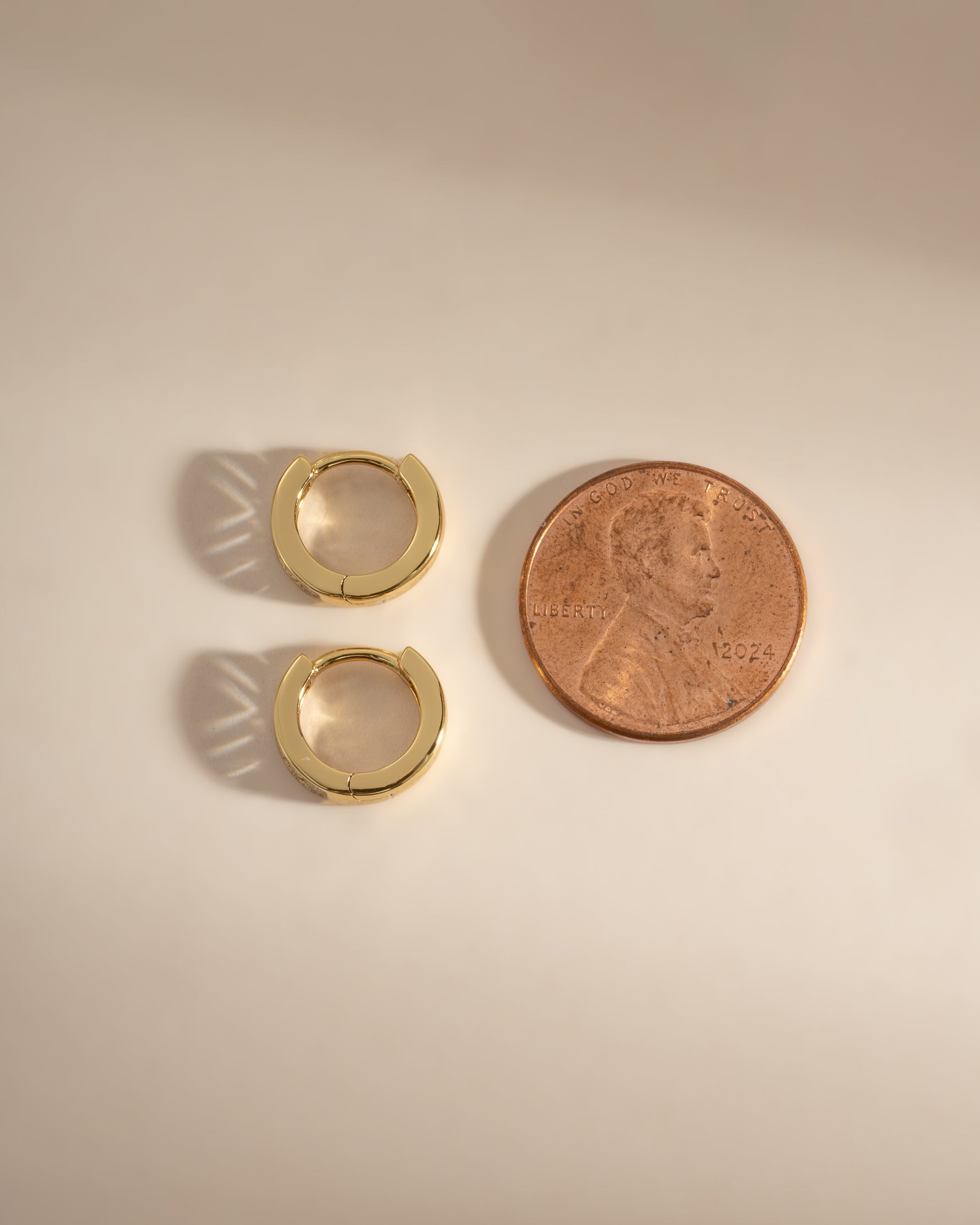 Gold Small Baguette Huggie Earrings by Sami Jewels, side profile view showcasing their sleek, minimalist design and secure fit.