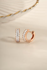 Rose gold Daryl-Ann's Baguette Hoops earrings by Sami Jewels, angled view showing sleek baguette design and huggie style.