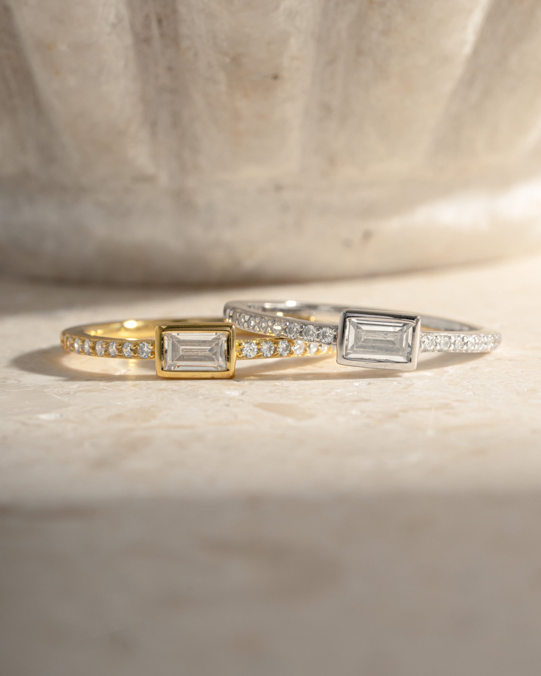 Gold and sterling silver baguette ring with pavé band by Sami Jewels, featuring sparkling gemstone accents.