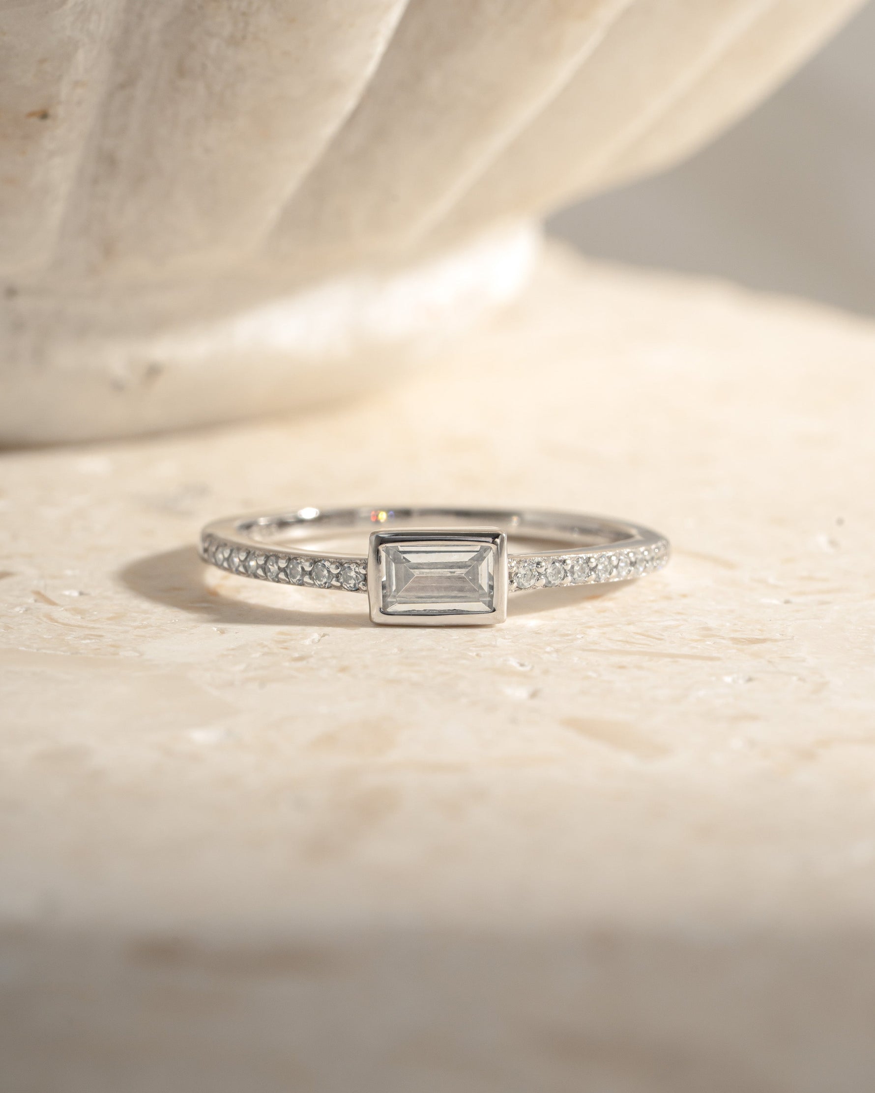 Sterling silver Baguette Ring with pavé band featuring sparkling baguette-cut stones, front view showcasing elegant design.