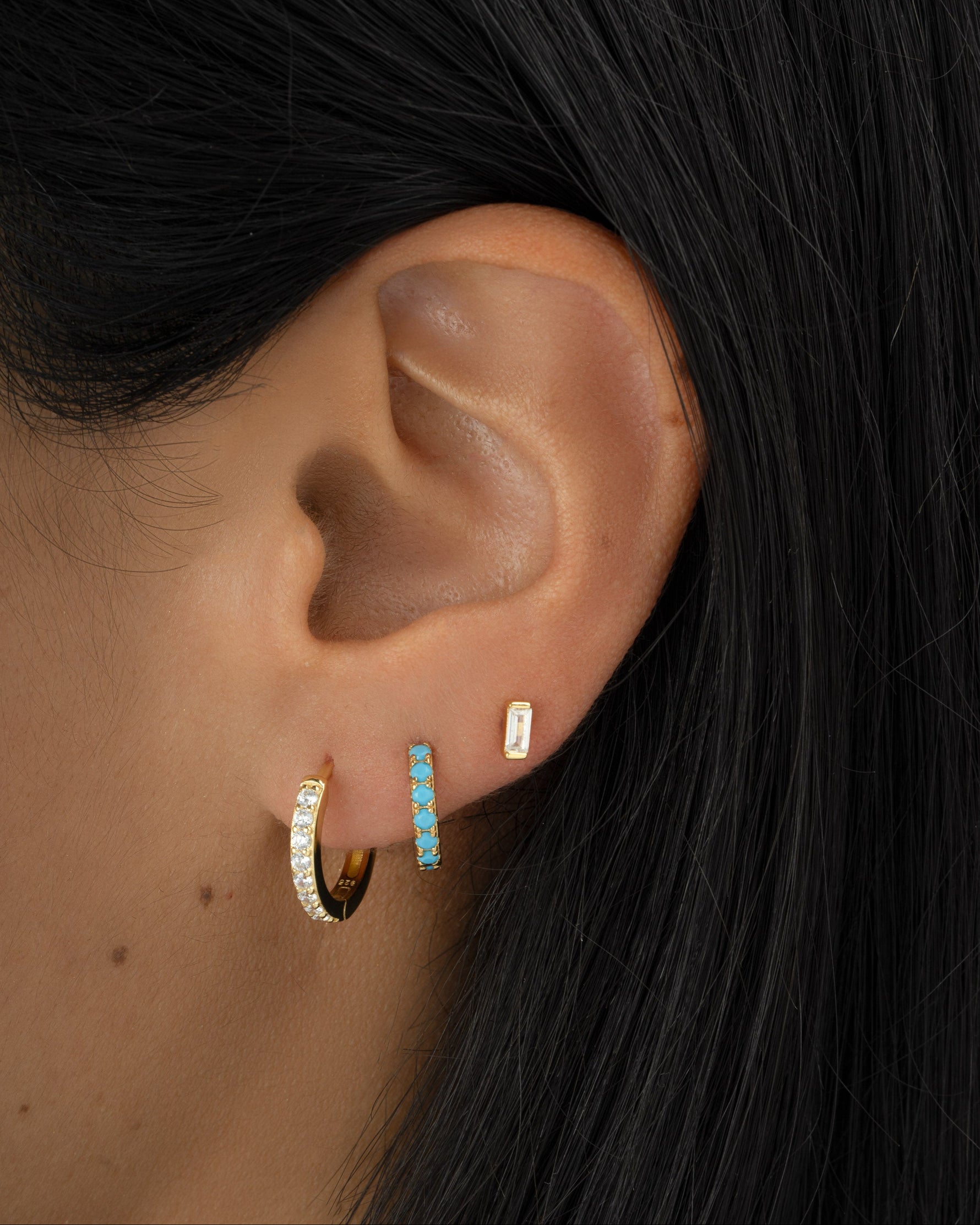 baguette diamond stud earring stack in gold on model