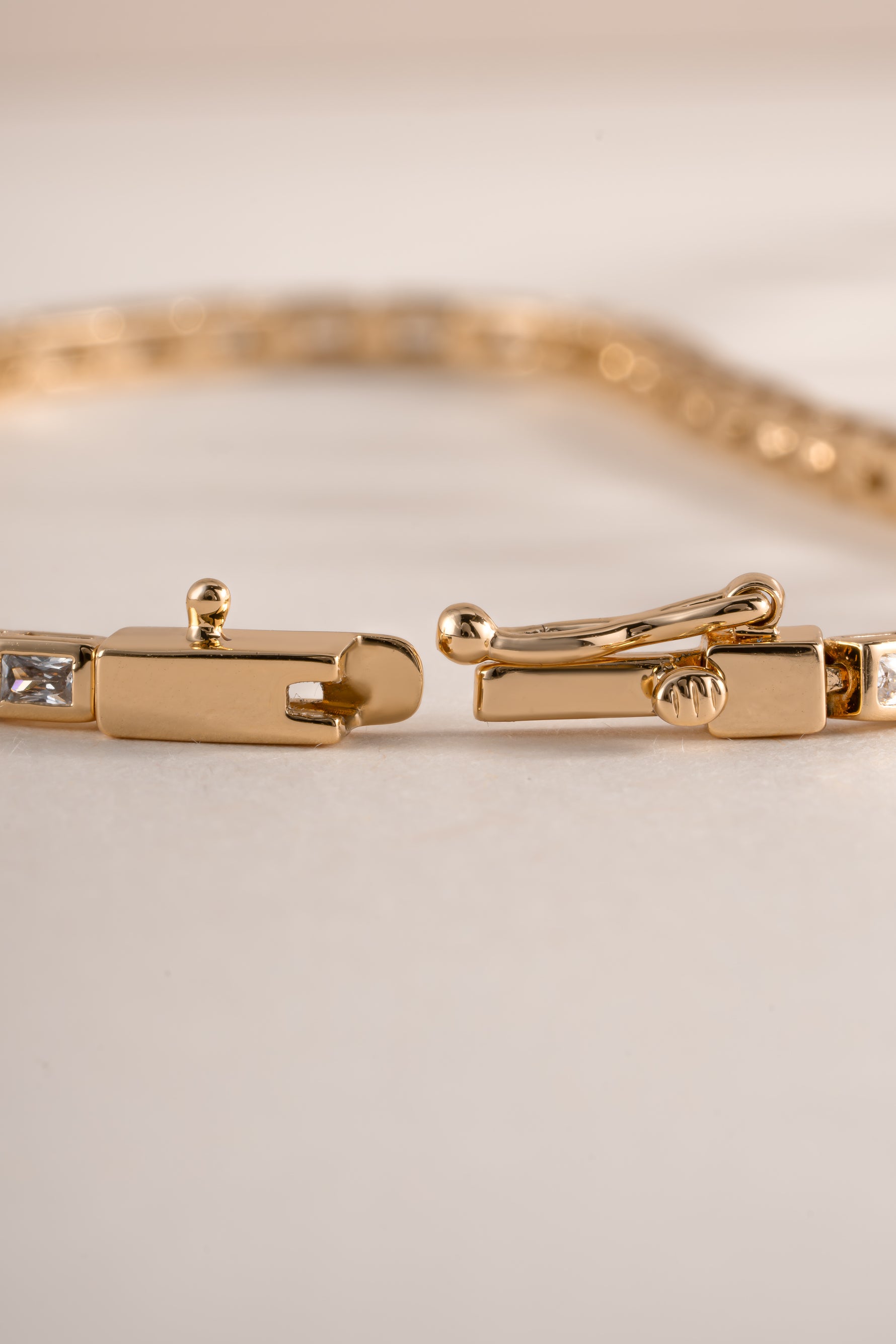 Sami Jewels Bezeled Baguette Tennis Bracelet with box clasp closure showcasing elegant rectangular gemstone settings.