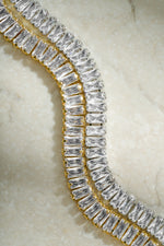 Gold and silver Baguette Tennis Bracelet by Sami Jewels showcasing alternating rectangular gemstones on a sleek bracelet.