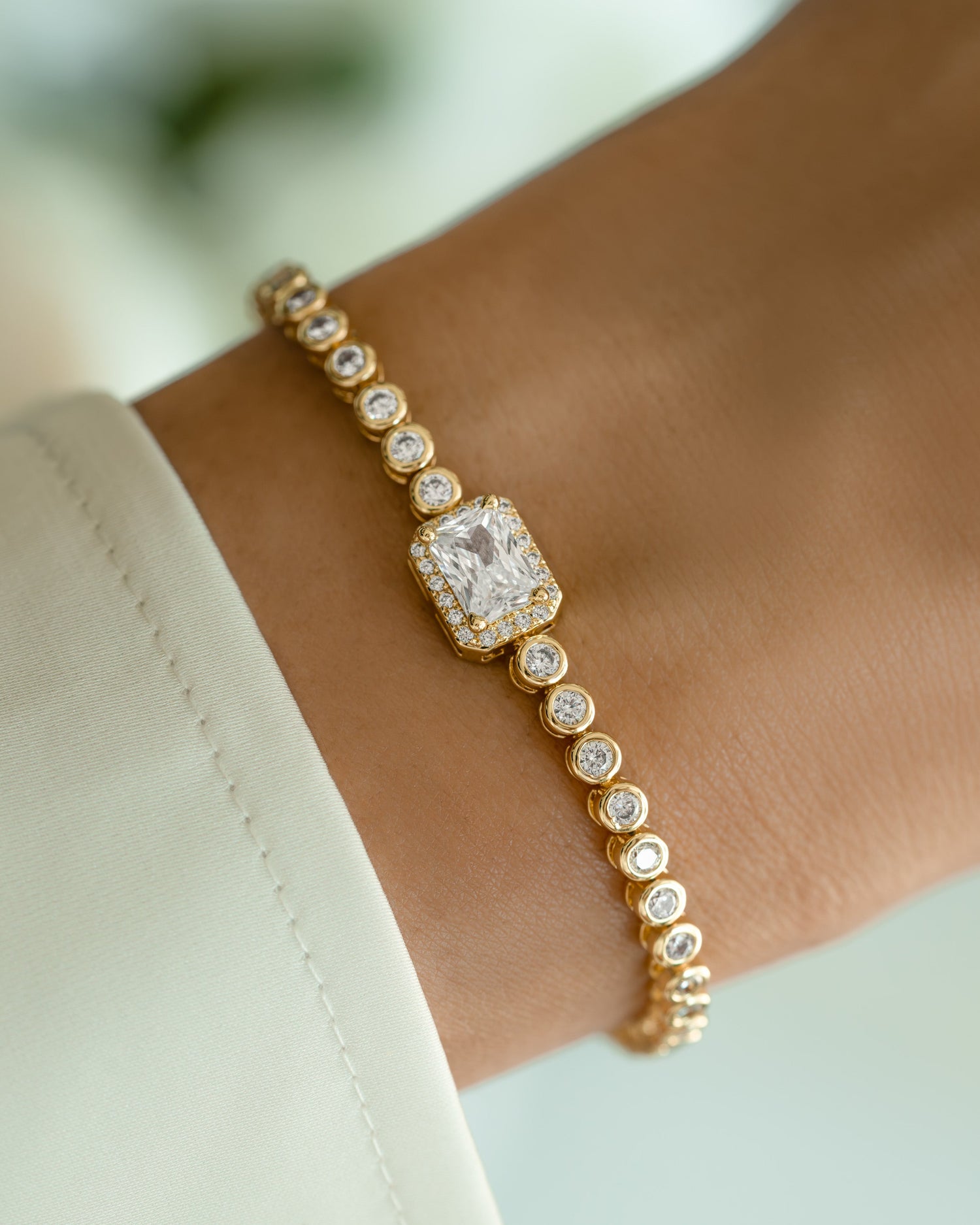 Gold CZ baguette rounded tennis bracelet by Sami Jewels featuring sparkling baguette-cut stones on a sleek bracelet design.