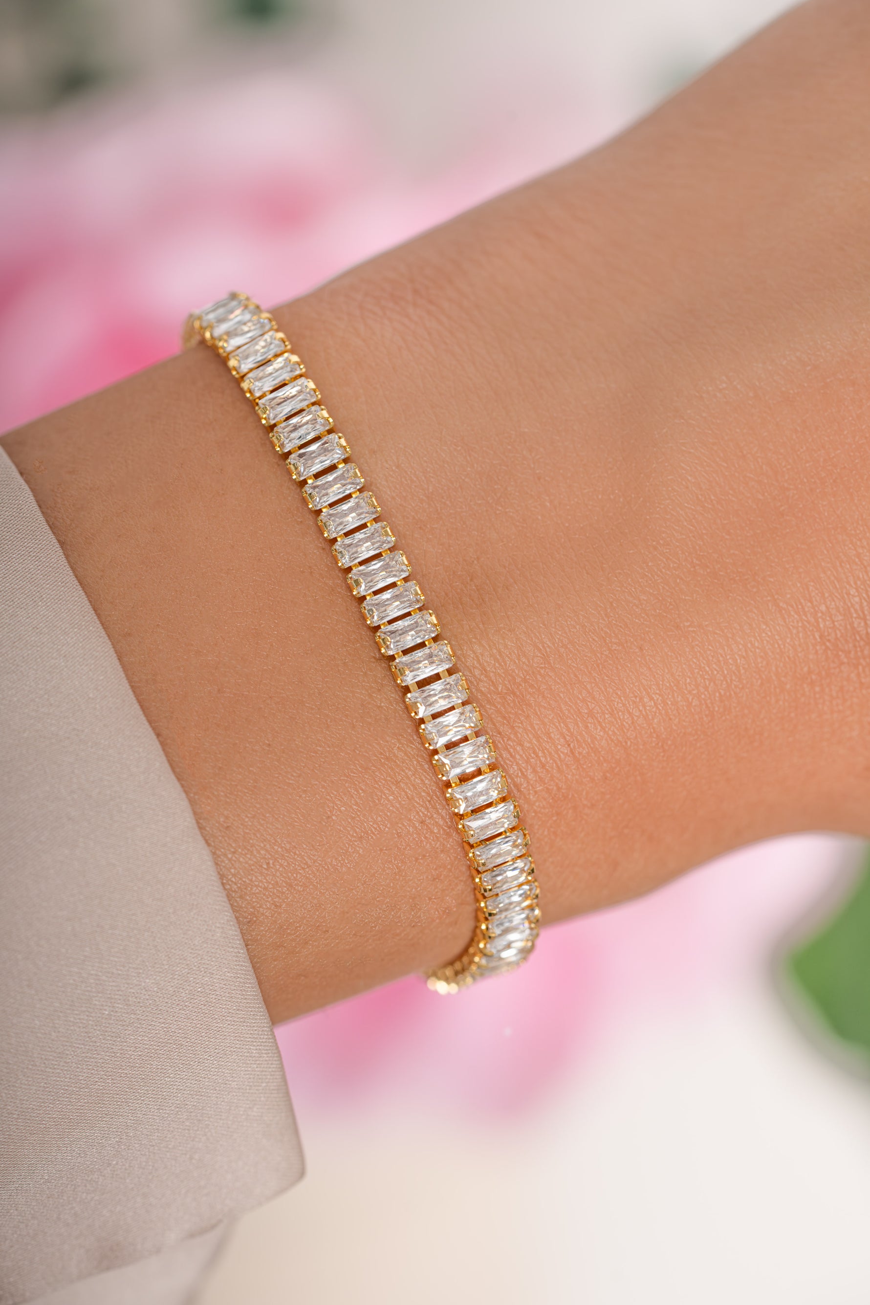 Gold Baguette Tennis Bracelet by Sami Jewels featuring rectangular-cut gemstones on a sleek bracelet design.